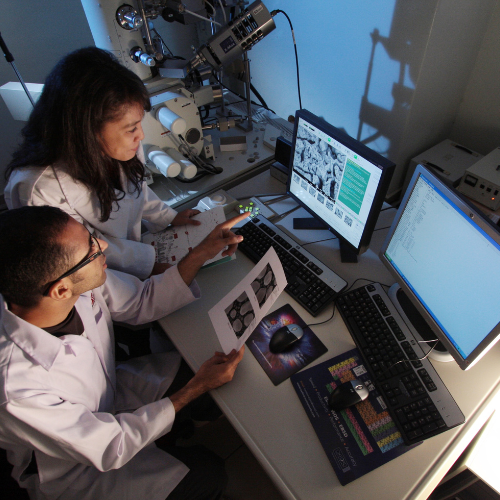 researchers standing at computer